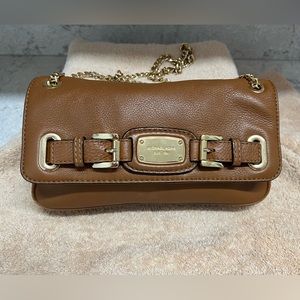 Michael Kors brown purse with adjustable gold chain strap in good condition